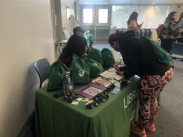 Student signing in at sign in table