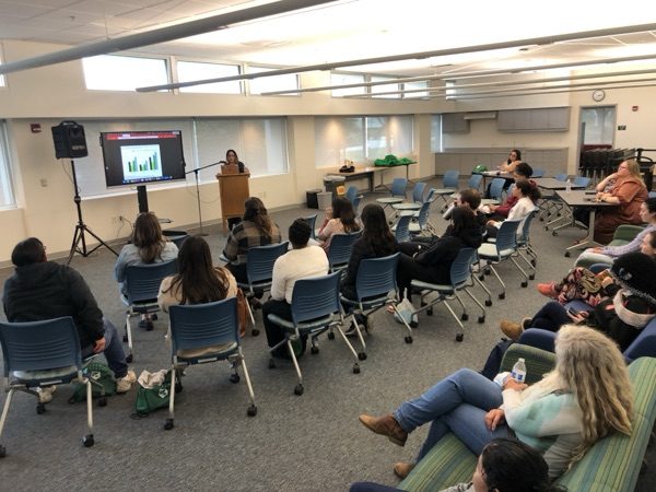 Students sitting in chairs listening to speaker