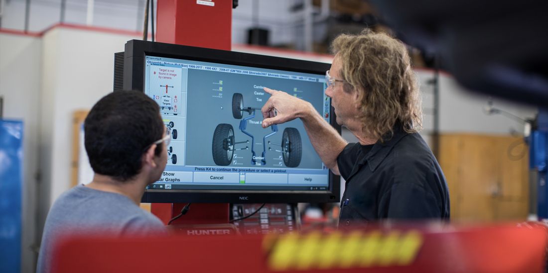 Automotive students looking at a computer screen
